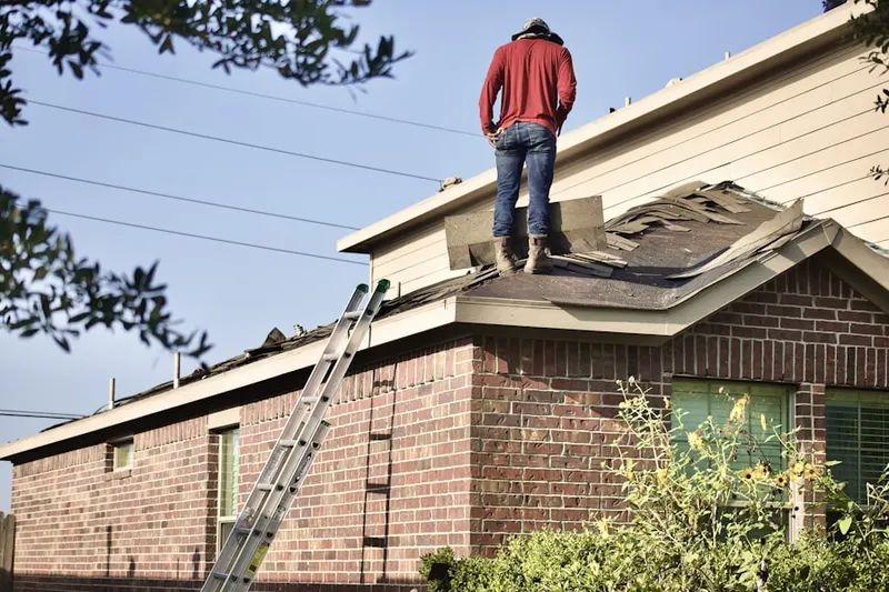 Professional roofer working on a residential roof in Conger Corners